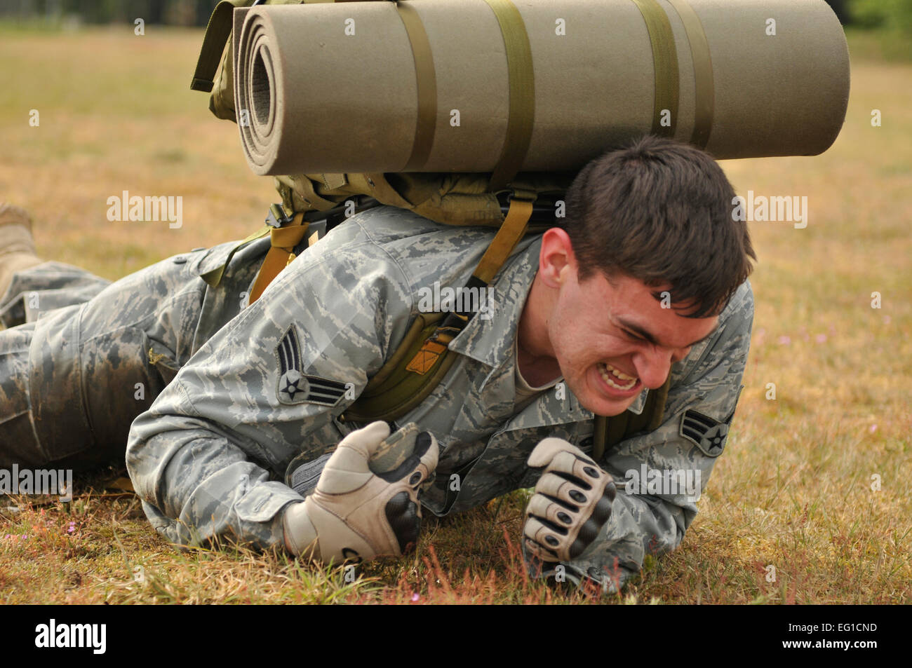 United States Air Force Senior Airman Ben Forbus, 48th delle forze di sicurezza Squadron patrolman, crawl alta con un 35-pound zaino durante il 5K combattere Ruck marzo sfida il 17 maggio 2011. Questo è uno dei vari eventi che si terranno durante la Polizia Nazionale settimana a RAF Lakenheath in onore di funzionari di polizia. La sfida necessaria ai team di gara tra quattro punti di verifica: 25 push-up, alta crawl, giochi di memoria e vigile del fuoco portano. Dei sette squadre in gara, Airman Forbus' team finito prima con un tempo di 36 minuti e 25 secondi. Senior Airman Tiffany M. Deuel Foto Stock