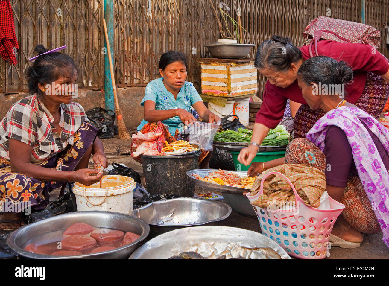Donne birmane di vendita alimentari sul terreno al mercato di Yangon / Rangoon, ex capitale del Myanmar / Birmania Foto Stock