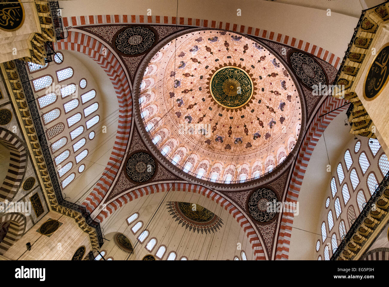 Moschea Suleymaniye dipinti della cupola interna Istanbul Turchia // ISTANBUL, Turchia - dipinti decorativi e calligrafia ornati adornano le cupole interne della Moschea Suleymaniye. I disegni intricati combinano motivi geometrici, motivi floreali e calligrafia islamica nello stile ottomano classico. Completati nel 1558, questi elementi decorativi mostrano la raffinatezza artistica raggiunta durante il regno del sultano Solimano. Foto Stock