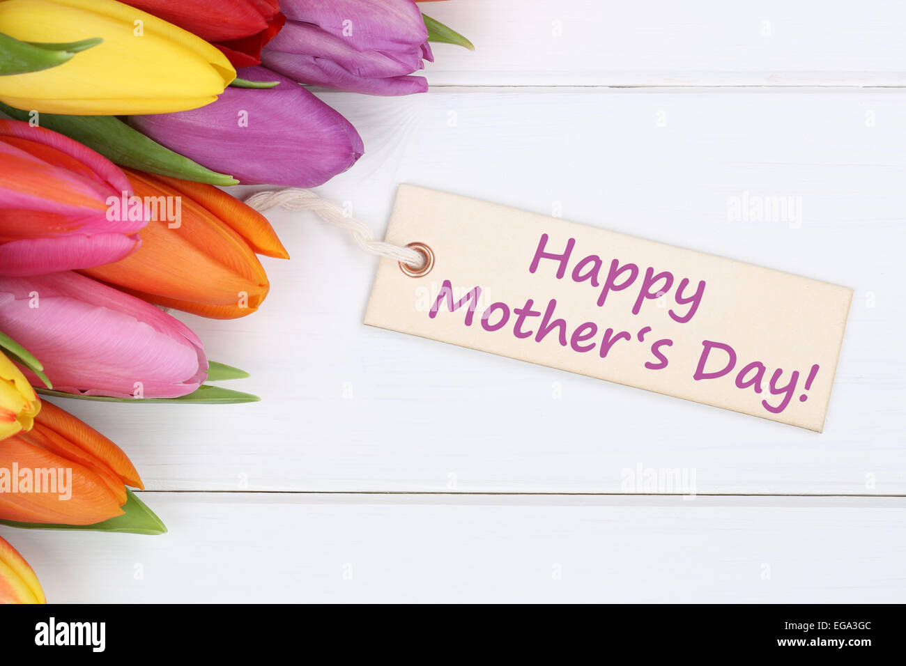 Felice giorno della madre con i tulipani fiori su un bianco tavola di legno Foto Stock