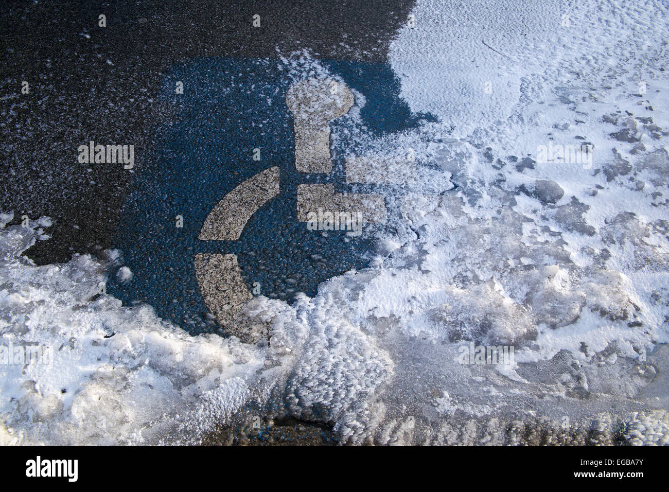 Handicap solo simbolo di parcheggio su terreni innevati spazio parcheggio. Foto Stock