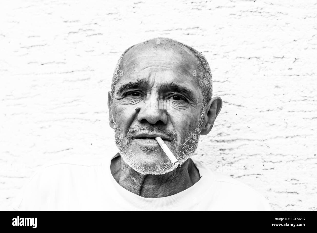 I vecchi diligente uomo stanco avente una pausa con una sigaretta Foto Stock