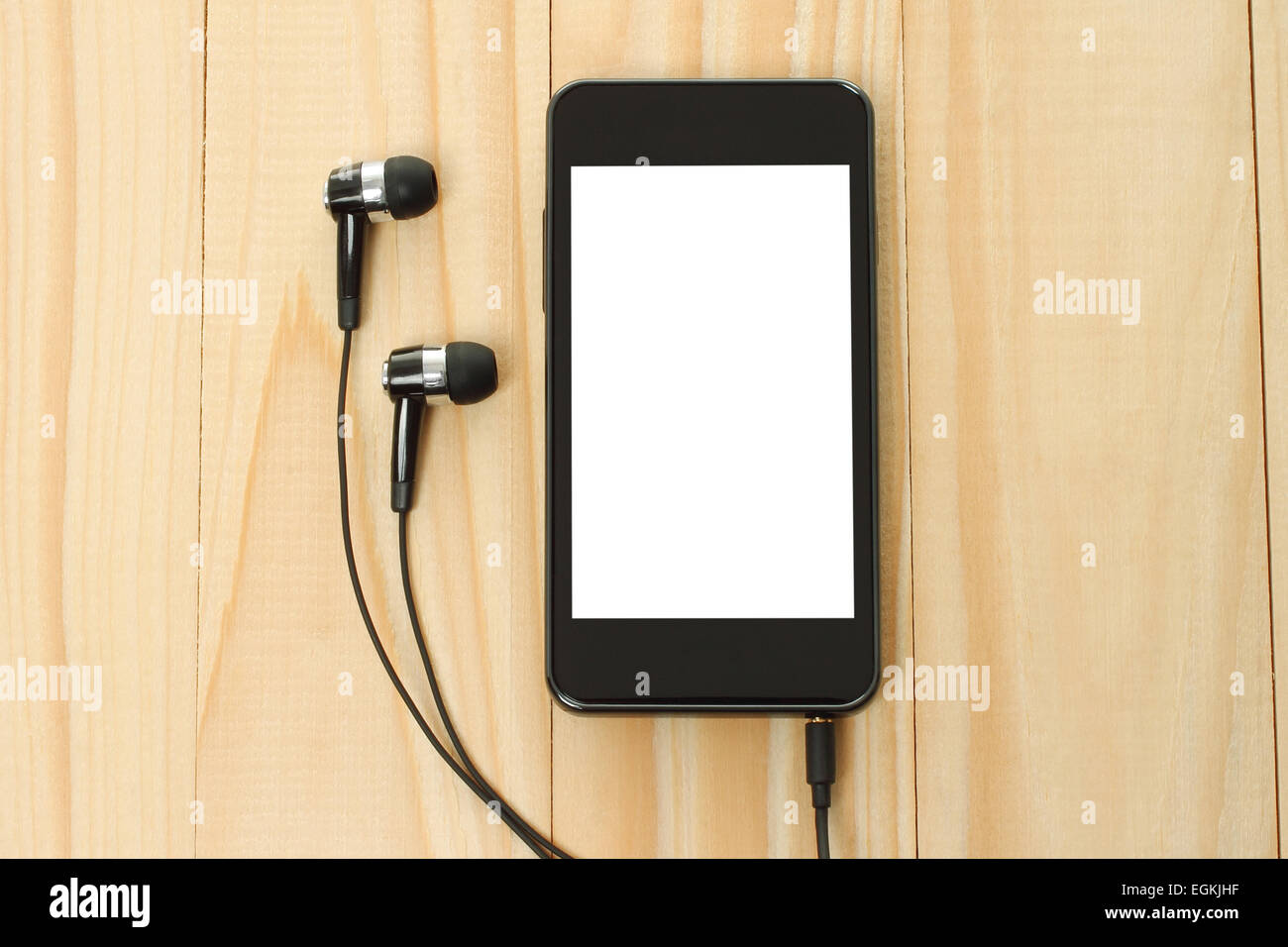 Smart phone con cuffie su sfondo di legno Foto Stock