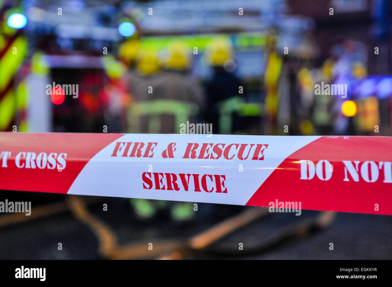 Vigili del fuoco posto cordon nastro intorno il sospetto di una scena di arson per tenere le persone sicure e conservare gli elementi di prova. Foto Stock