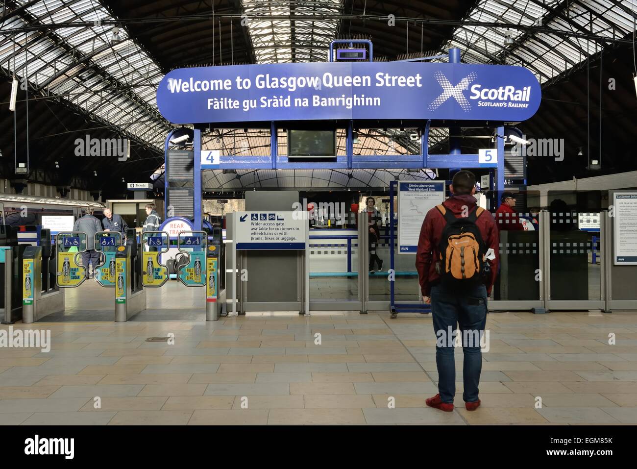 Segno positivo anche in gaelico, in la stazione di Queen Street a Glasgow, Scotland, Regno Unito Foto Stock