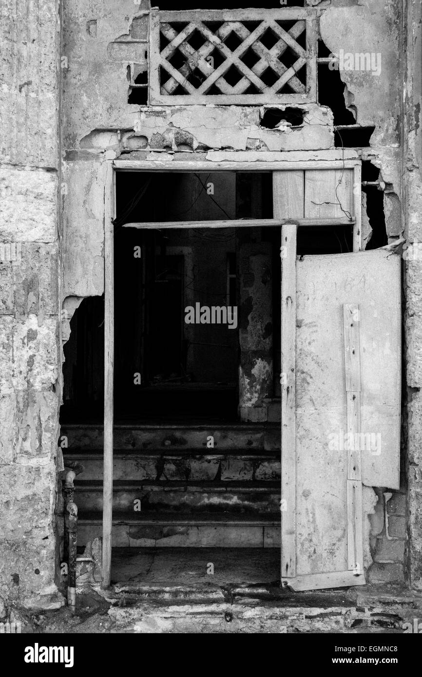 Ingresso di uno sbriciolamento coloniale edificio di appartamenti in Havana, Cuba Foto Stock