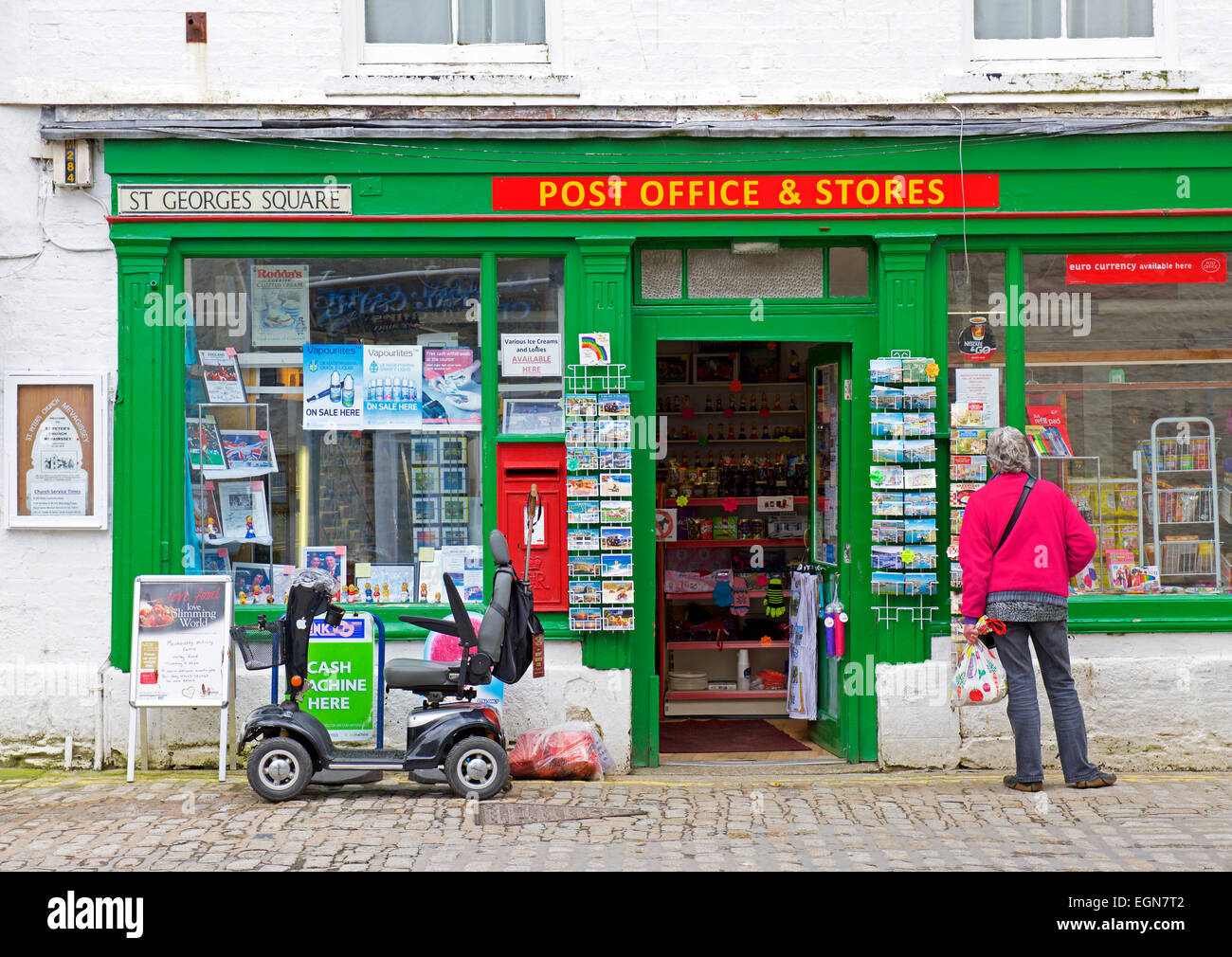 La donna al di fuori del villaggio post office, Mevagissey, Cornwall, England Regno Unito Foto Stock