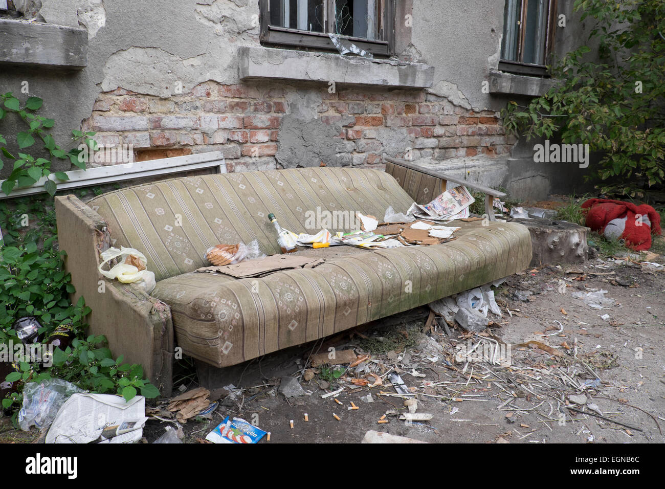 Home abbandonati con divano abbandonati al di fuori Foto Stock