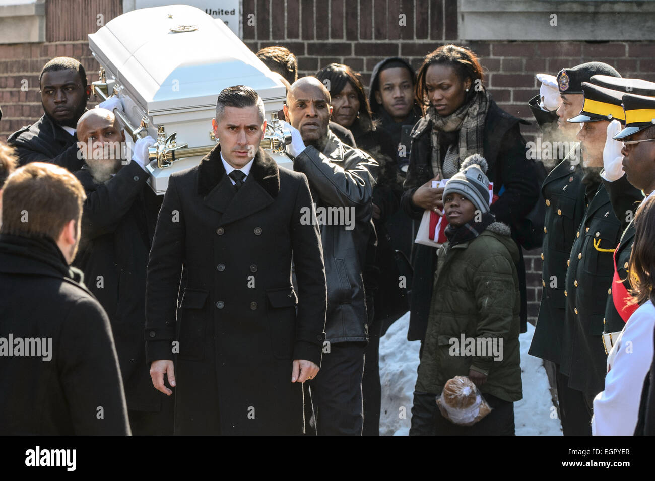 Toronto, Canada. Il 28 febbraio 2015. Georgette Marsh, madre di Elia e il suo fratello più anziano, camminare insieme come il suo giovane figlio è scrigno è posto in attesa funebre. Persone in lutto si sono riuniti presso St. Matthews Chiesa unita su St Clair Avenue West per rendere omaggio a 3-anno-vecchio Elia Marsh. Credito: Victor Biro/Alamy Live News Foto Stock