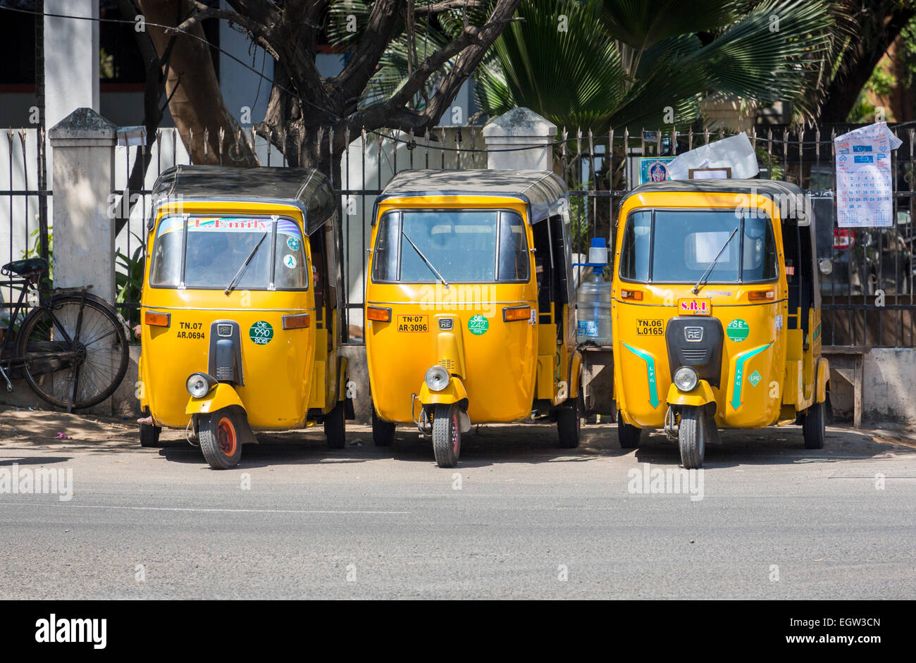 Fila di tre gialli di tuk-tuks per noleggio, parcheggiato in una strada di Chennai, nello Stato del Tamil Nadu, nell India meridionale Foto Stock
