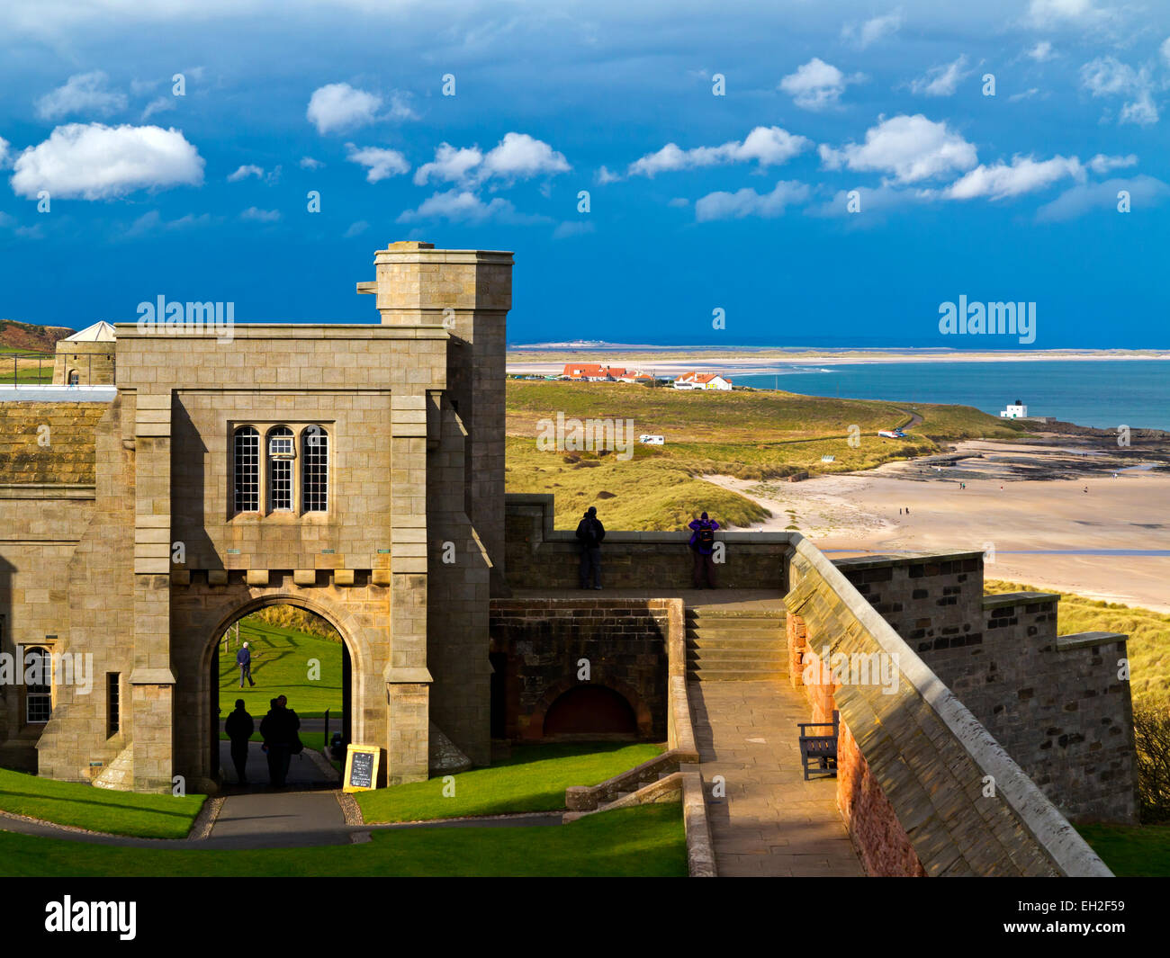 Vista di un gateway arcuata nella torre di Neville nel castello di Bamburgh con coste in background in Northumberland England Regno Unito Foto Stock