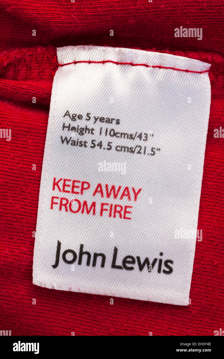 Tenere lontano dal fuoco di John Lewis etichetta nel bambino indumento superiore Foto Stock