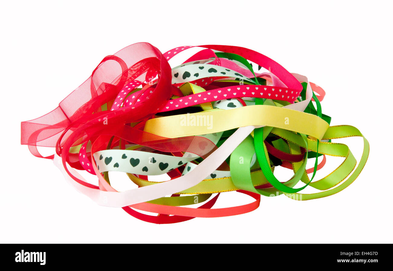 Pila di nastro assortiti in rosso, verde, giallo e rosa. Foto Stock