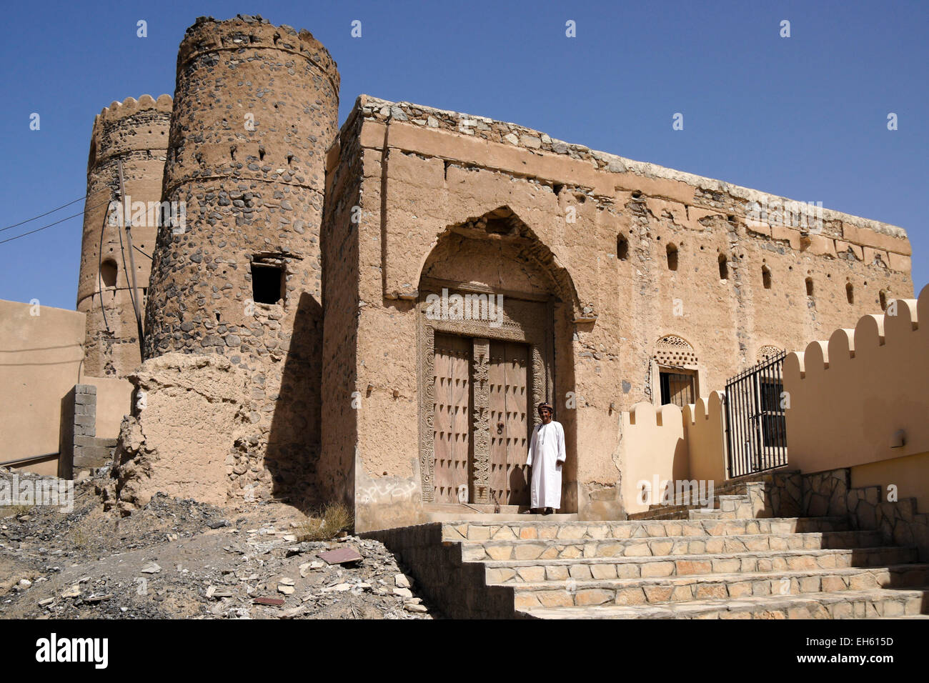 Uomo in legno intagliato porta del vecchio edificio mudbrick, Al-Mudayrib, Oman Foto Stock