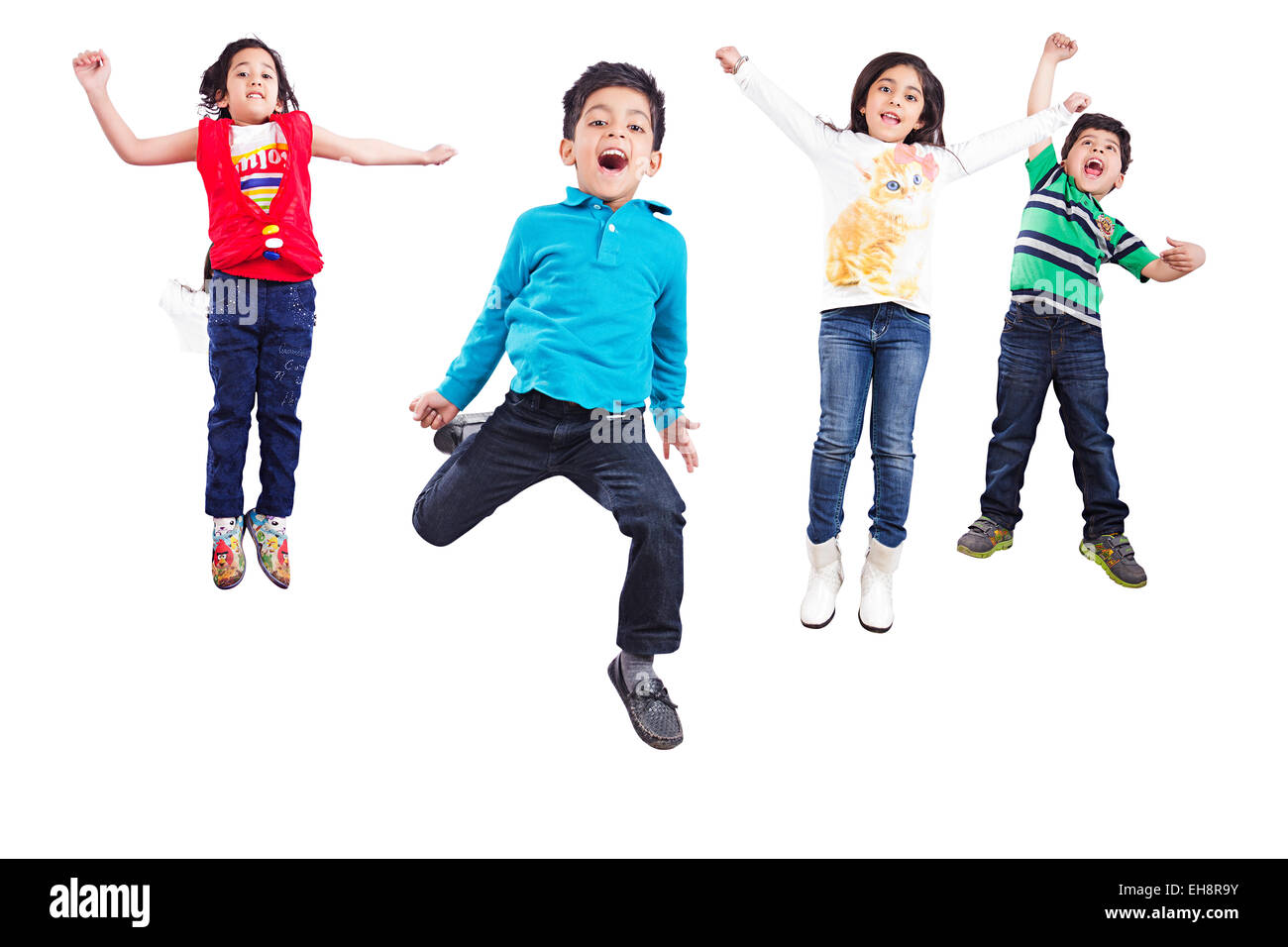 4 bambini indiani amici Jumping gridando fun Foto Stock