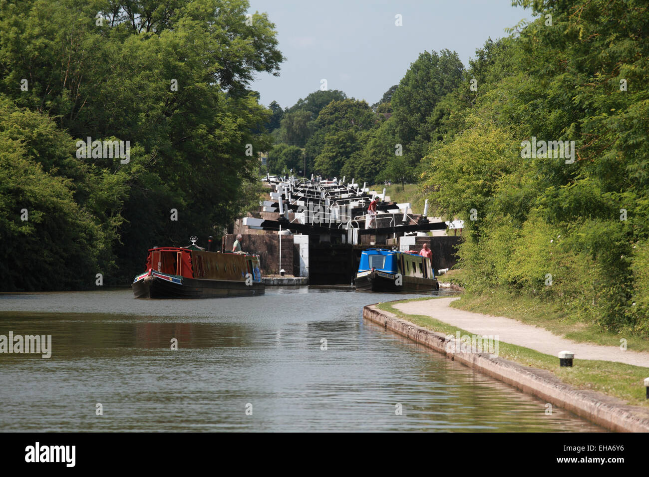 Due narrowboats lasciando doppia serratura 37 del Hatton volo sul Grand Union Canal vicino a Warwick Foto Stock