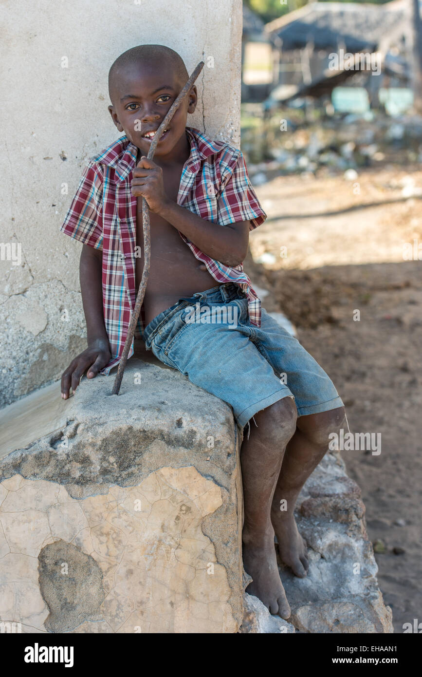 Kilwa, Lindi, ragazzo seduto su una parete Foto Stock