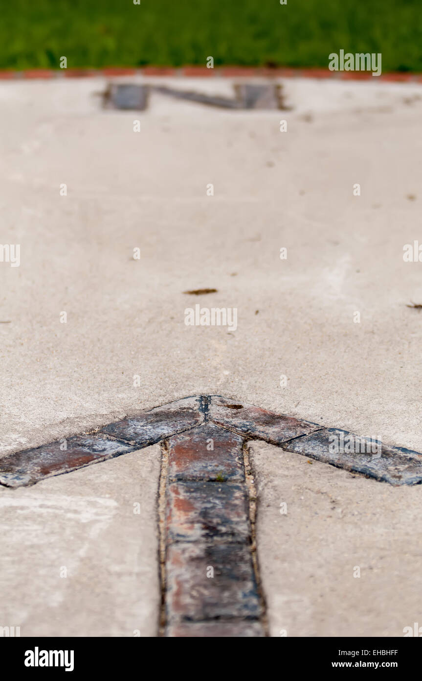 Mattone lastricatore freccia nord bussola Foto Stock