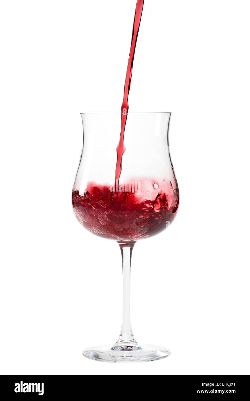 Vino rosso spruzzi in un bicchiere Foto Stock