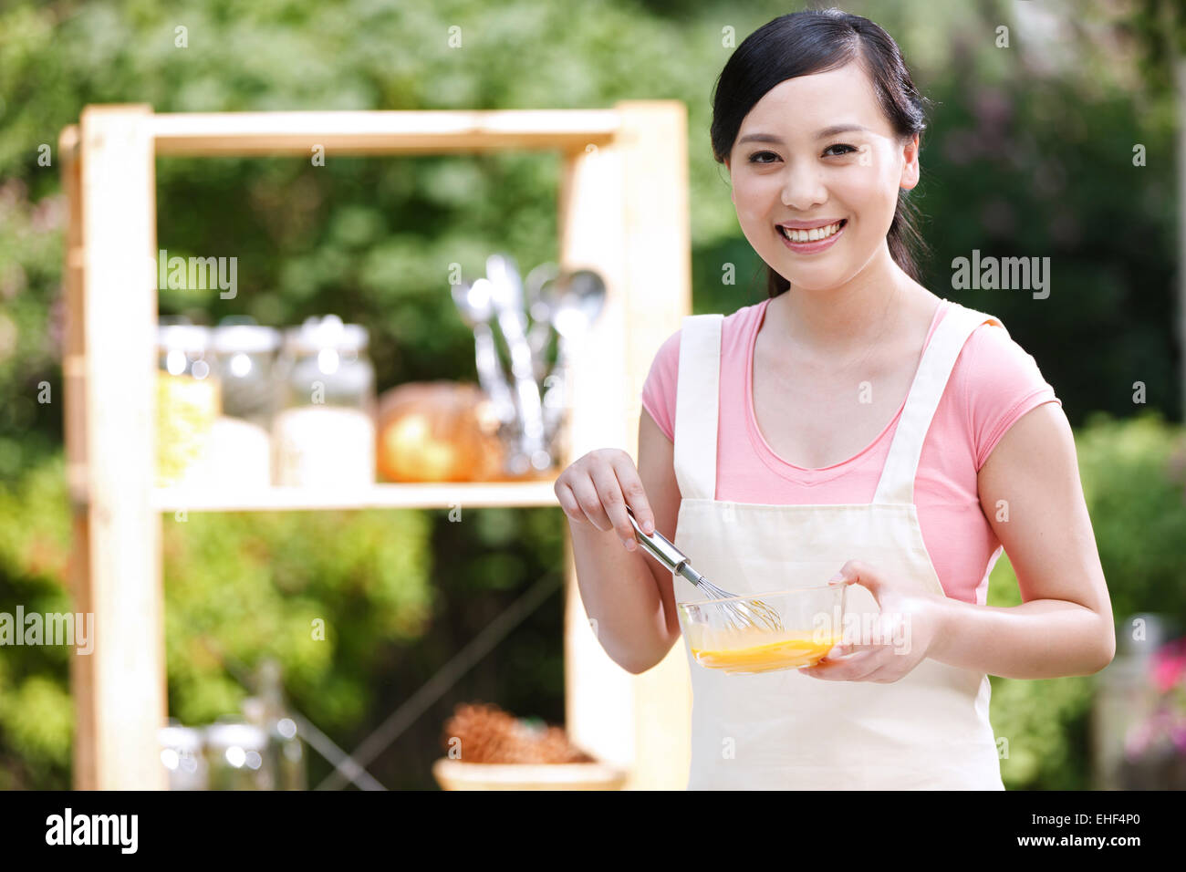 La casalinga che prepara il cibo nella cucina esterna Foto Stock