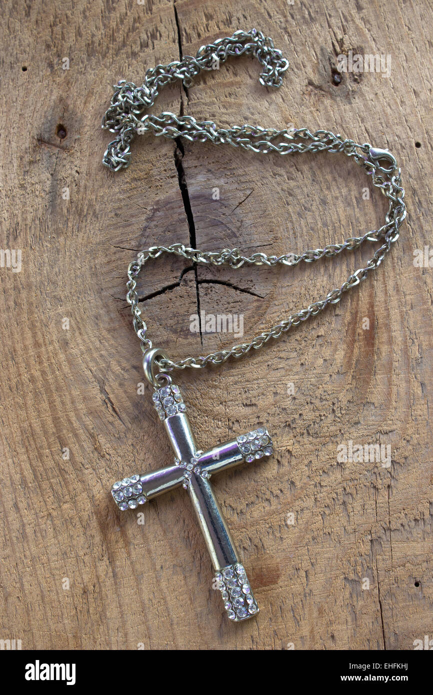 Argento croce cristiana Collana con diamanti su sfondo di legno Foto Stock