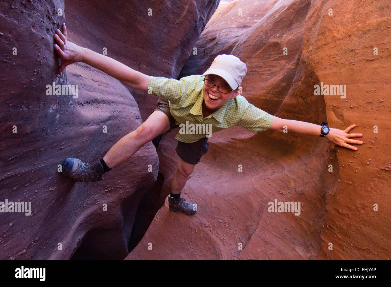 Donna di esplorare uno slot canyon in grande scala Escalante National Monument, Utah Foto Stock