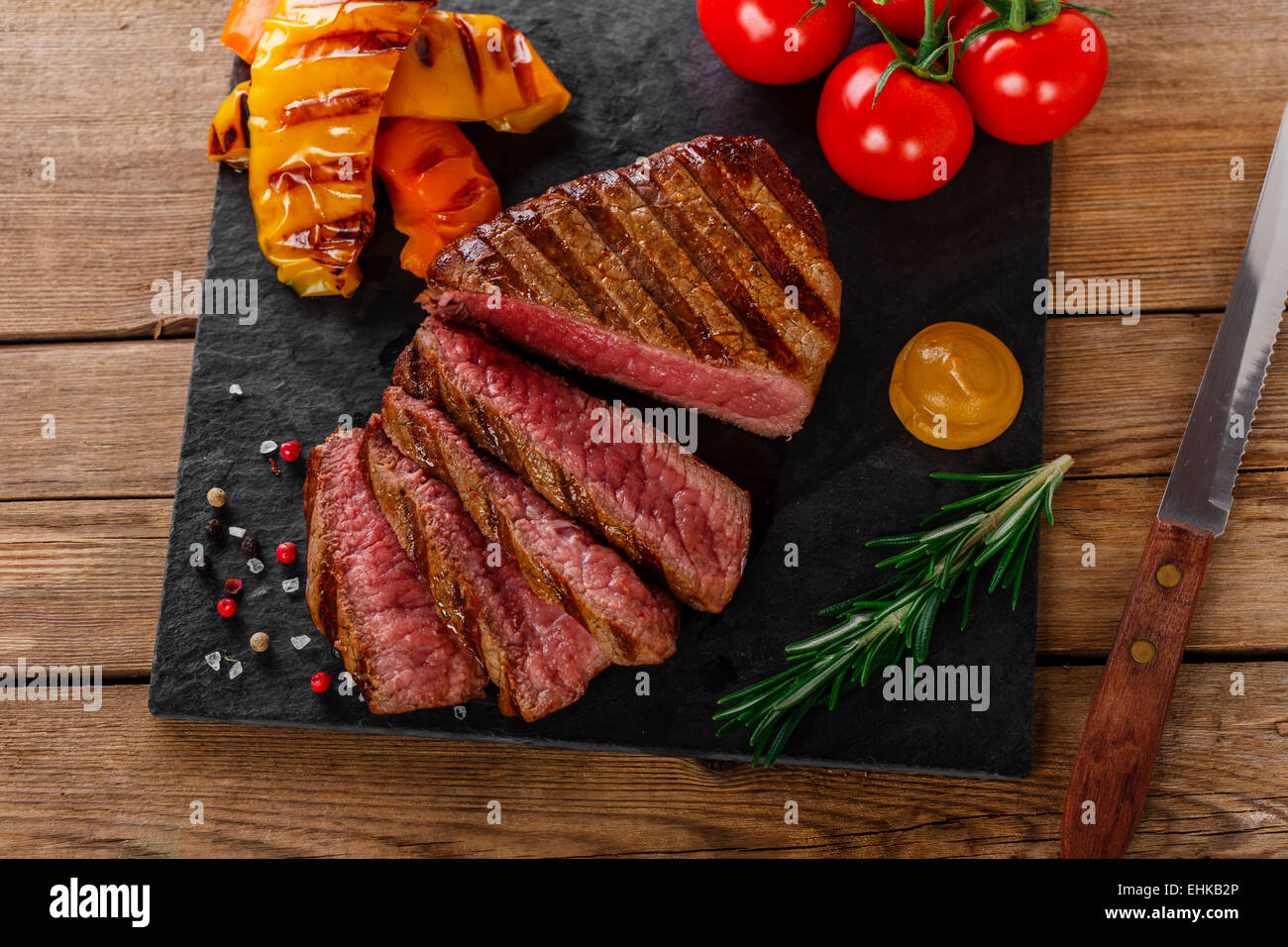 Grigliate di carne di manzo tagliata a fette rare con verdure Foto Stock