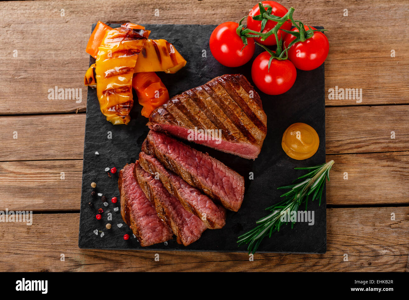 Grigliate di carne di manzo tagliata a fette rare con verdure Foto Stock