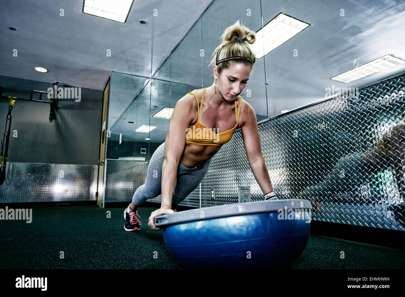 La donna caucasica facendo spingere ups in palestra Foto Stock