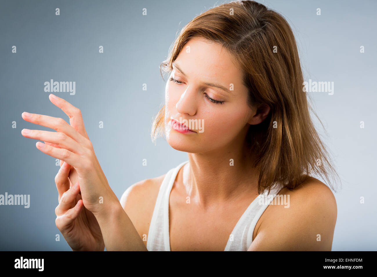 Donna di ispezionare la sua mano. Foto Stock