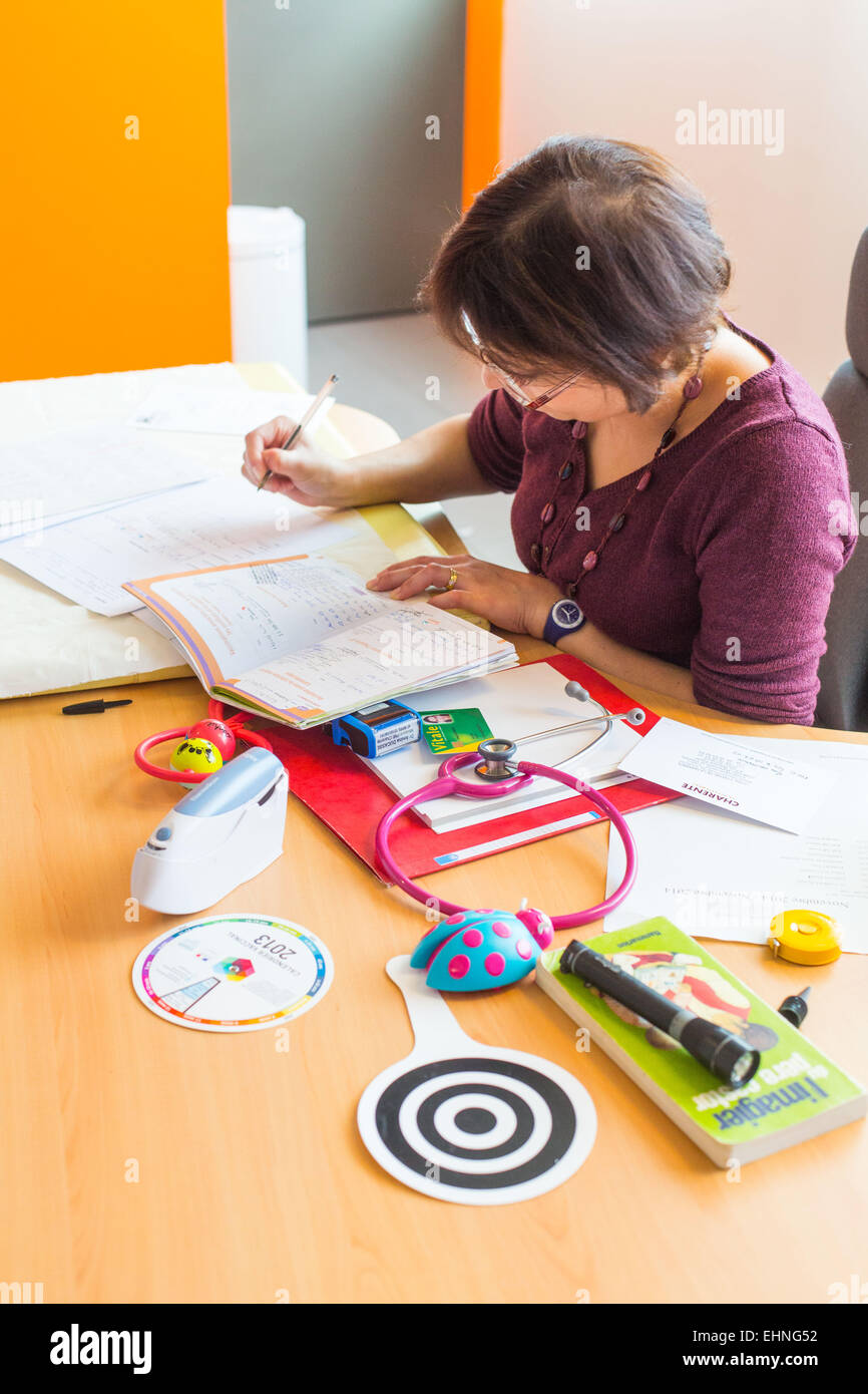 Medico il riempimento in un bambino salute notebook, materno e il benessere dei bambini, Charente, Francia. Foto Stock