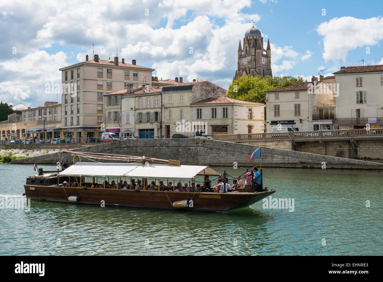 Saintes in Francia con la barca sul fiume Charente e le nuvole nel cielo blu. Foto Stock