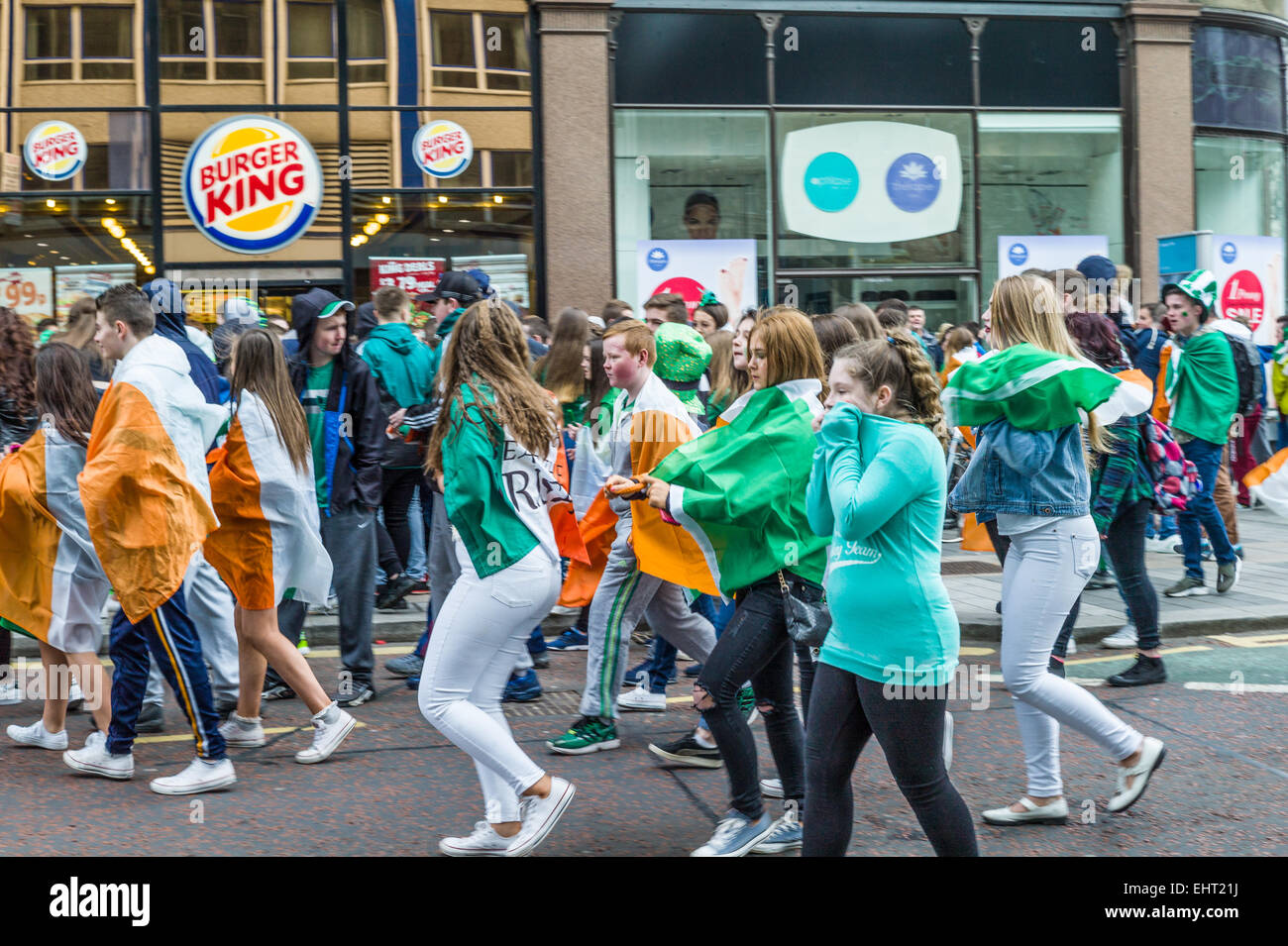 Gruppi rivali repubblicani drappeggiati in irlandese Tricolors e sindacalisti sventolando bandiere Unione affacciate nella parte anteriore del Municipio. Foto Stock