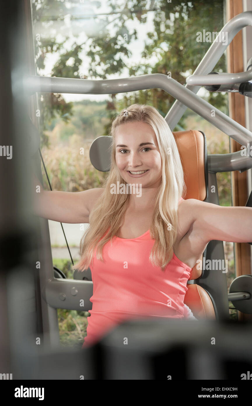 Attraente sorridente donna bionda studio fitness Foto Stock