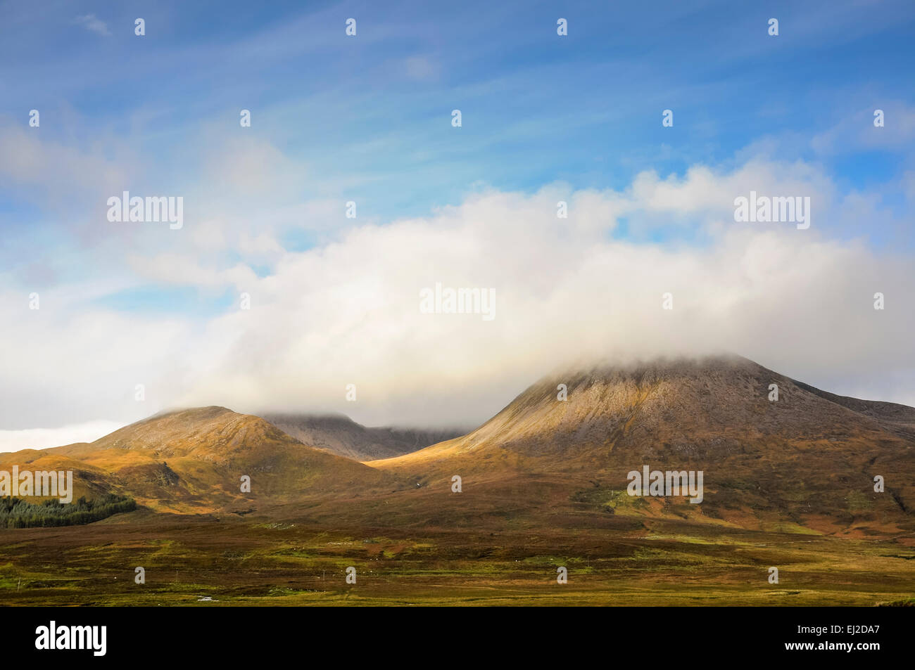 Le colline rosse (rosso) Cuillins sull'Isola di Skye in Scozia. Basse nubi intorno le cime delle montagne. Foto Stock