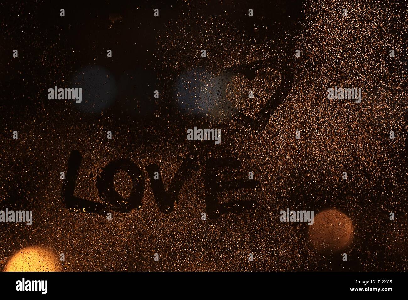 Iscrizione amore sul vetro bagnato di notte Foto Stock