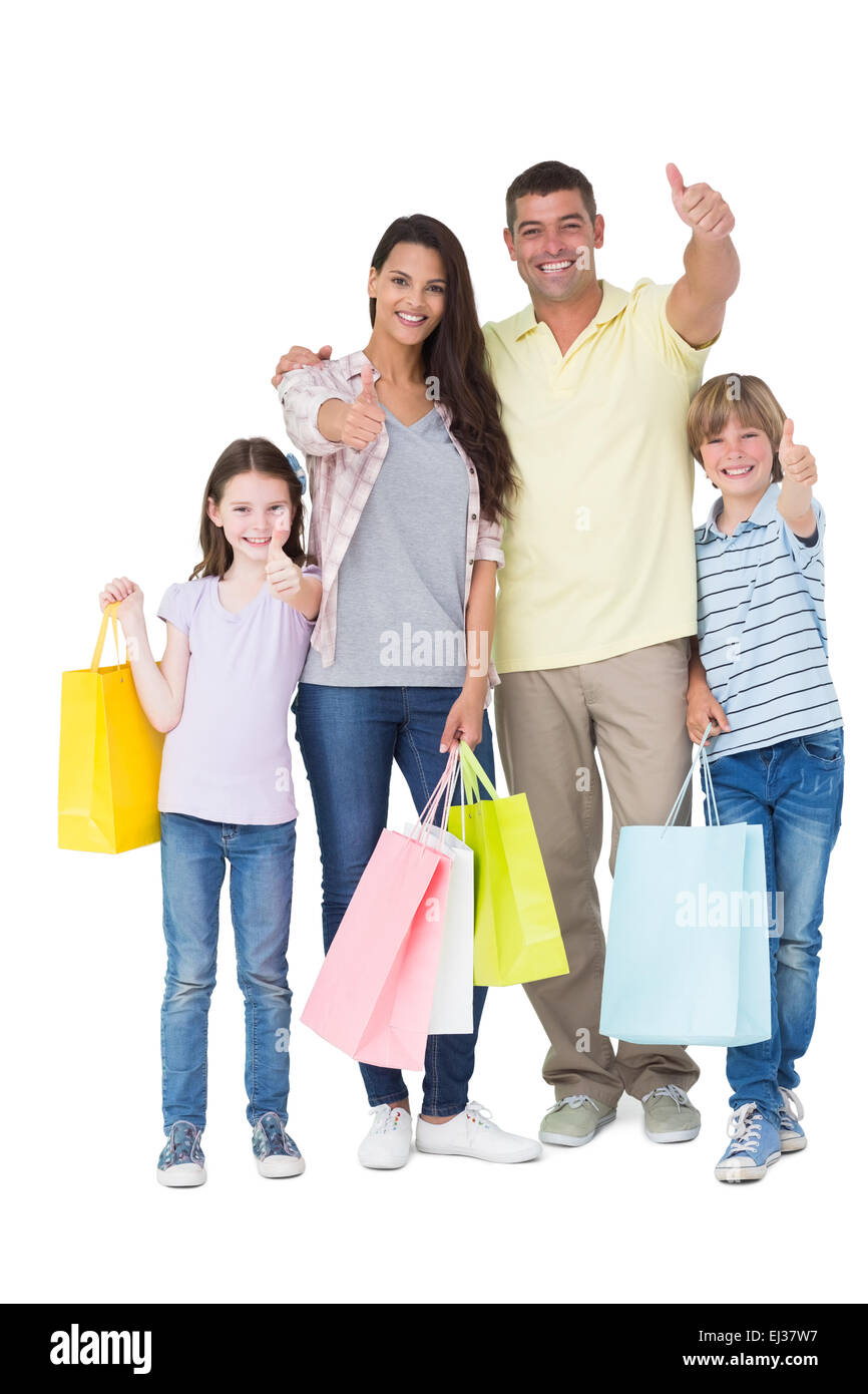 Famiglia con shopping bags gesticolando pollice in alto Foto Stock