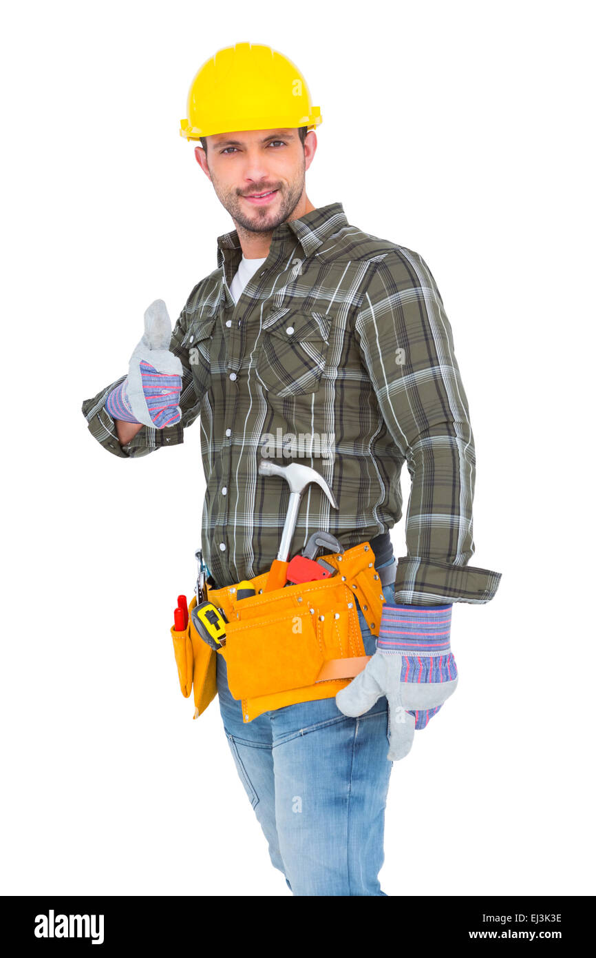 Fiducioso lavoratore manuale gesticolando pollice in alto Foto Stock