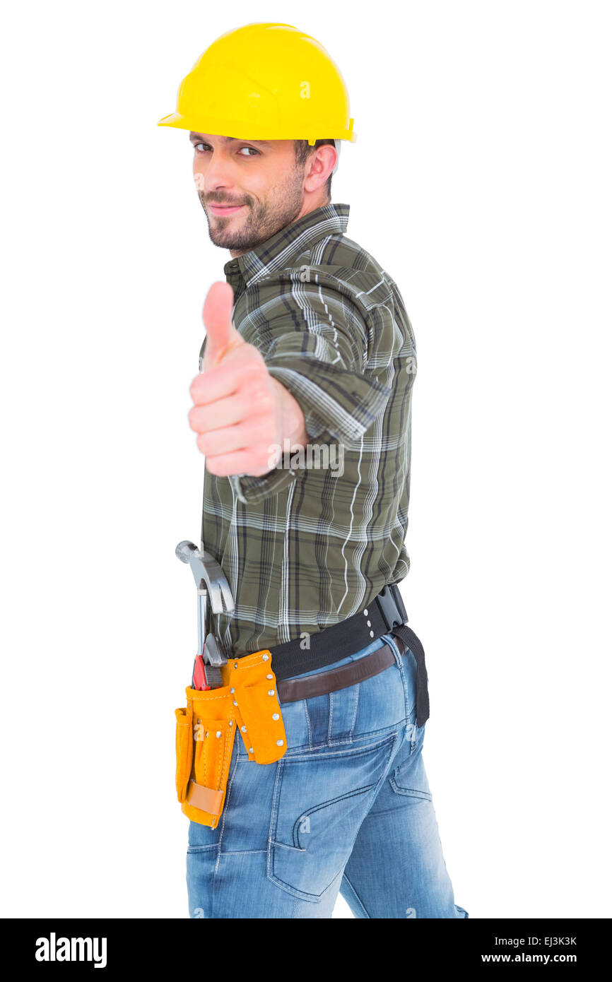 Fiducioso lavoratore manuale gesticolando pollice in alto Foto Stock