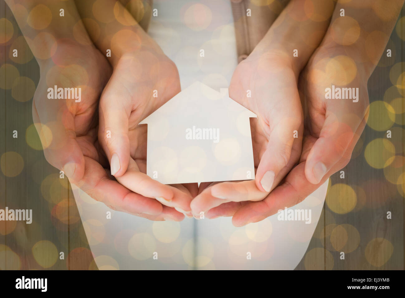 Immagine composita della giovane azienda casa in miniatura in mani Foto Stock