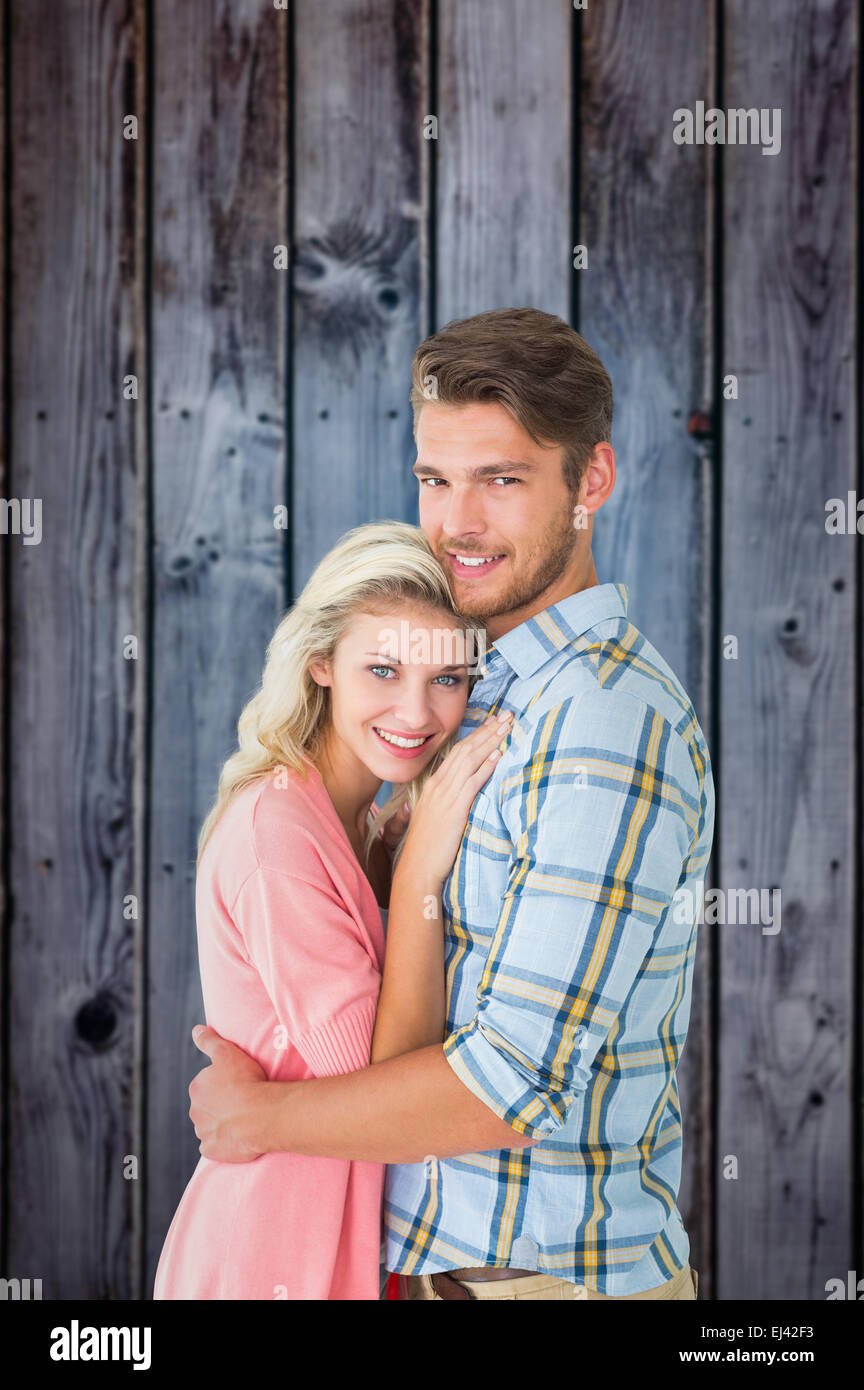 Immagine composita della coppia attraente abbracciando e sorridente in telecamera Foto Stock
