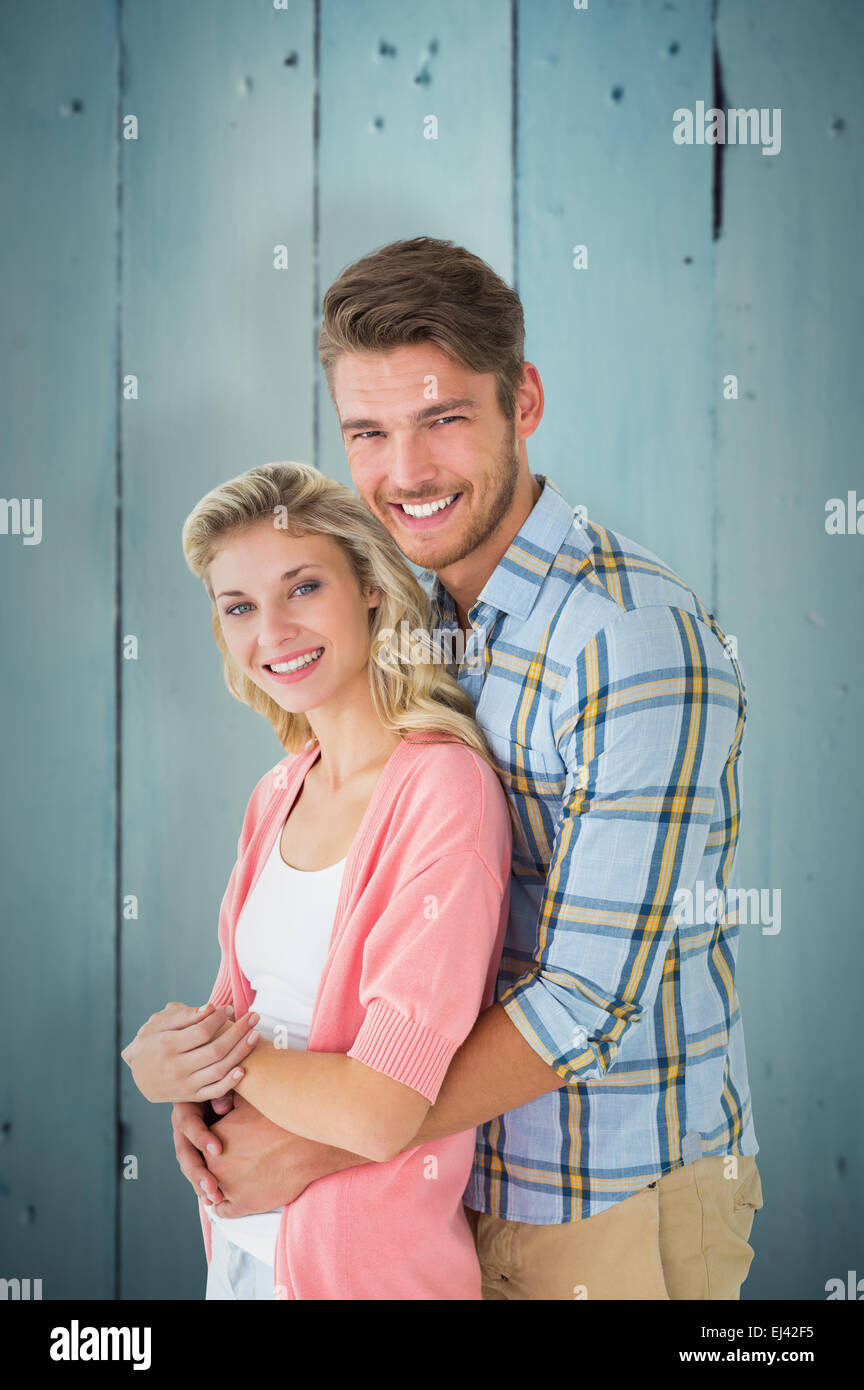 Immagine composita della coppia attraente abbracciando e sorridente in telecamera Foto Stock