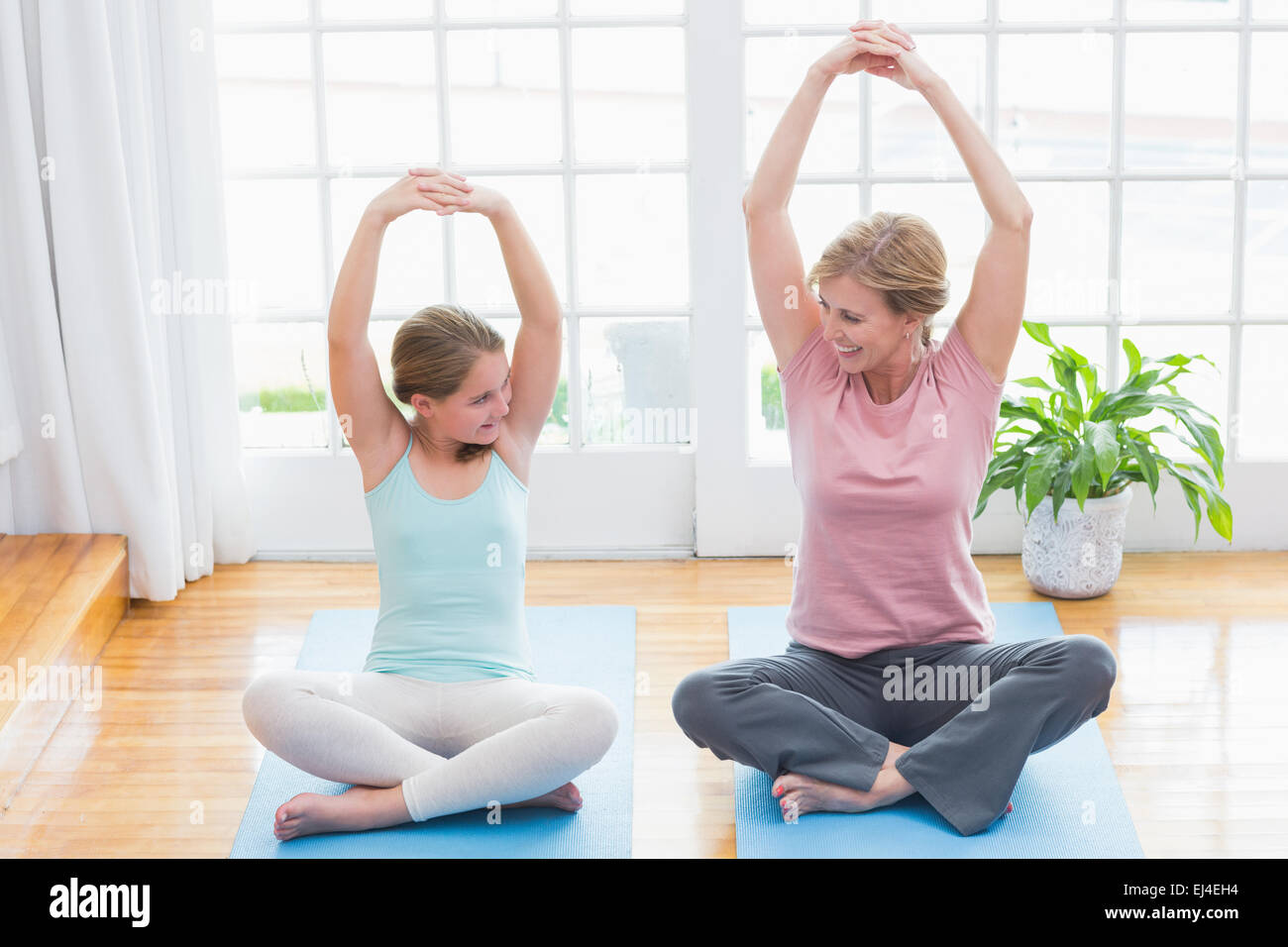 Madre e figlia fare yoga sul tappetino fitness Foto Stock