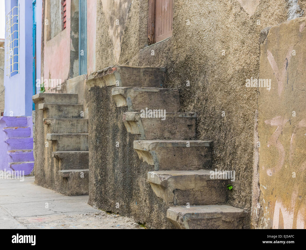 Tre gruppi di concreti passi di casa di design simile lungo una strada di Santiago de Cuba. Foto Stock