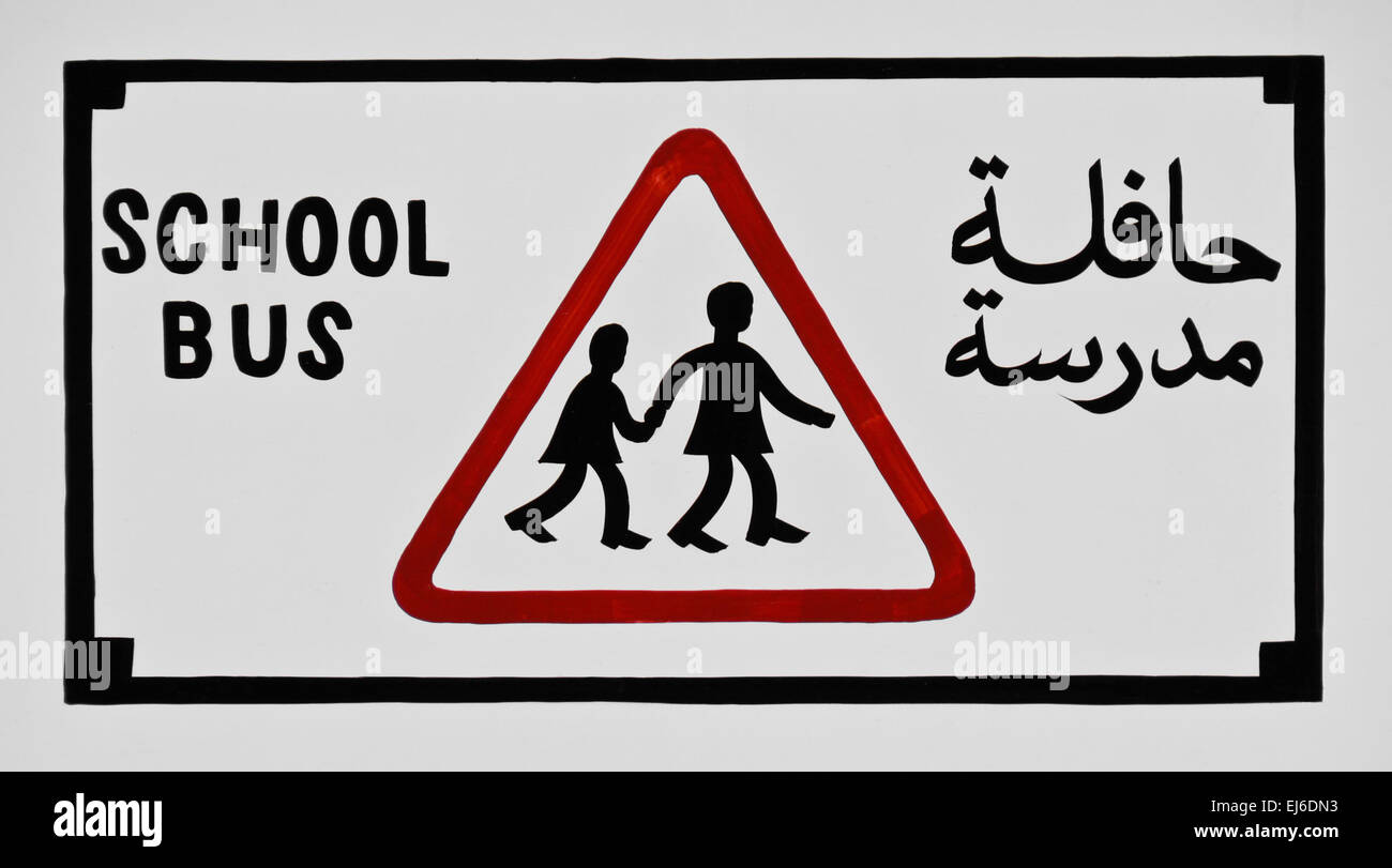 Scuola bus segno di attenzione in inglese e arabo Foto Stock