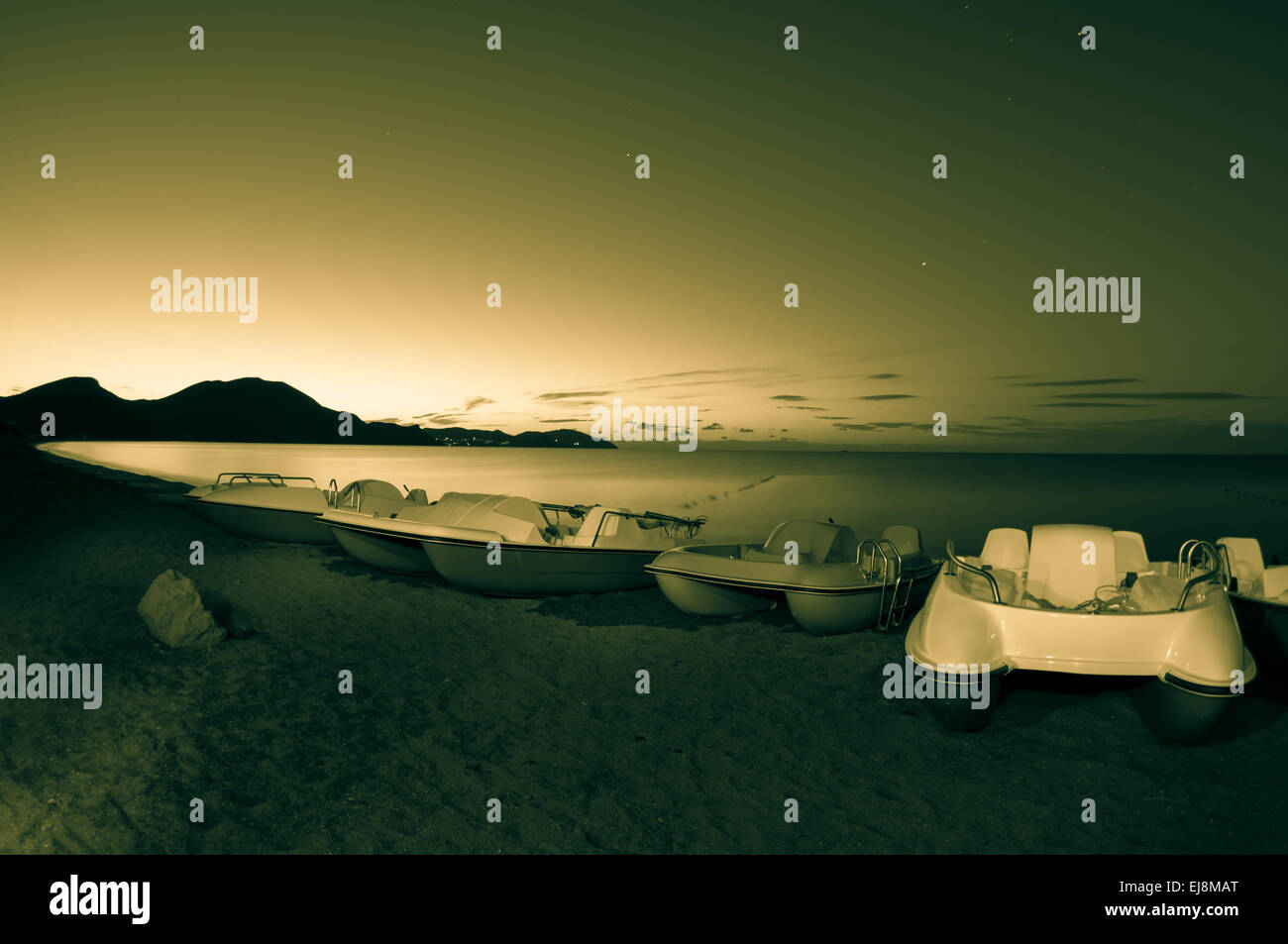 Barche a pedali sulla spiaggia di notte. Foto Stock