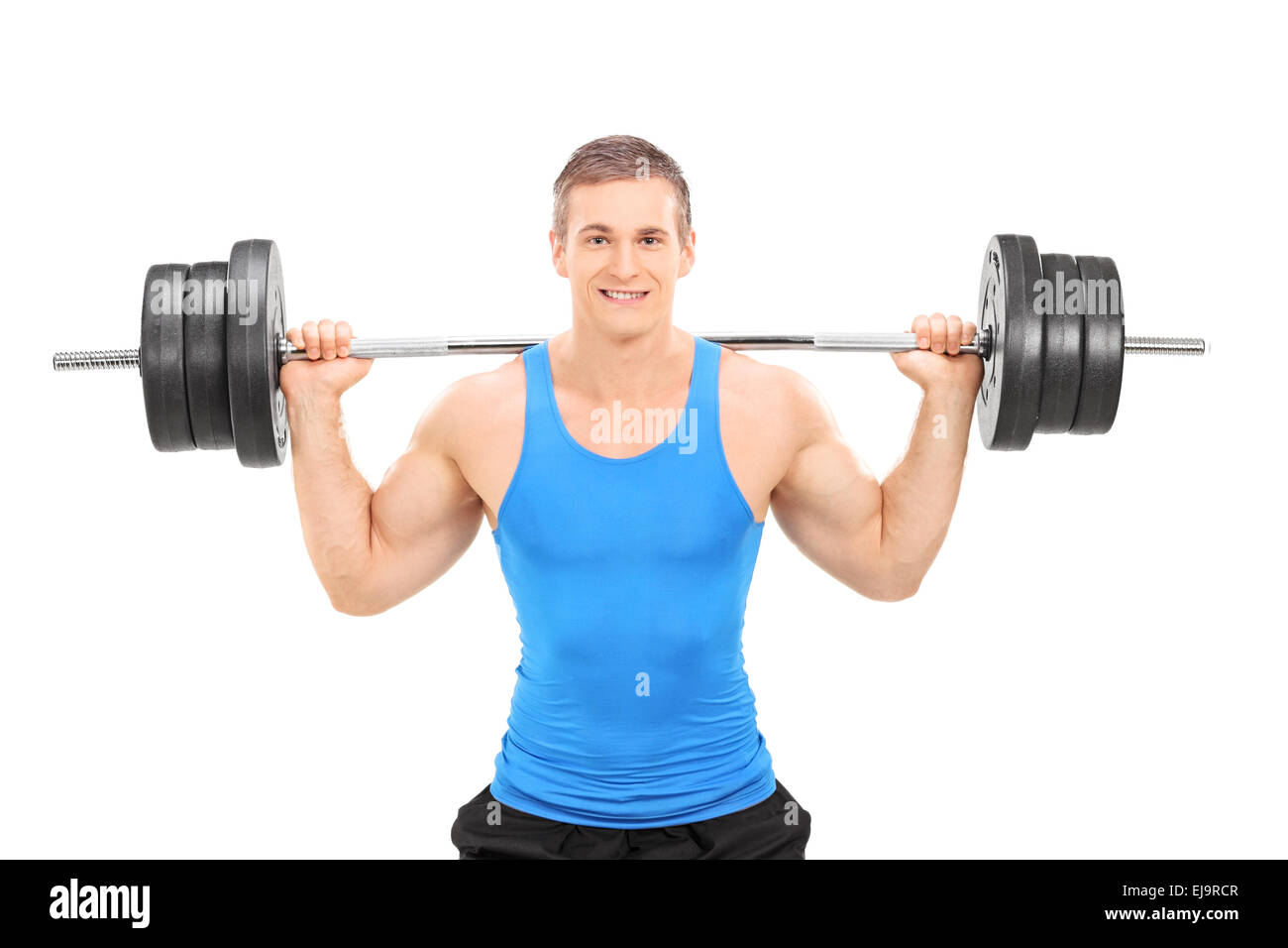 Giovane atleta sorridente in maglietta blu esercizio con un peso pesante isolati su sfondo bianco Foto Stock