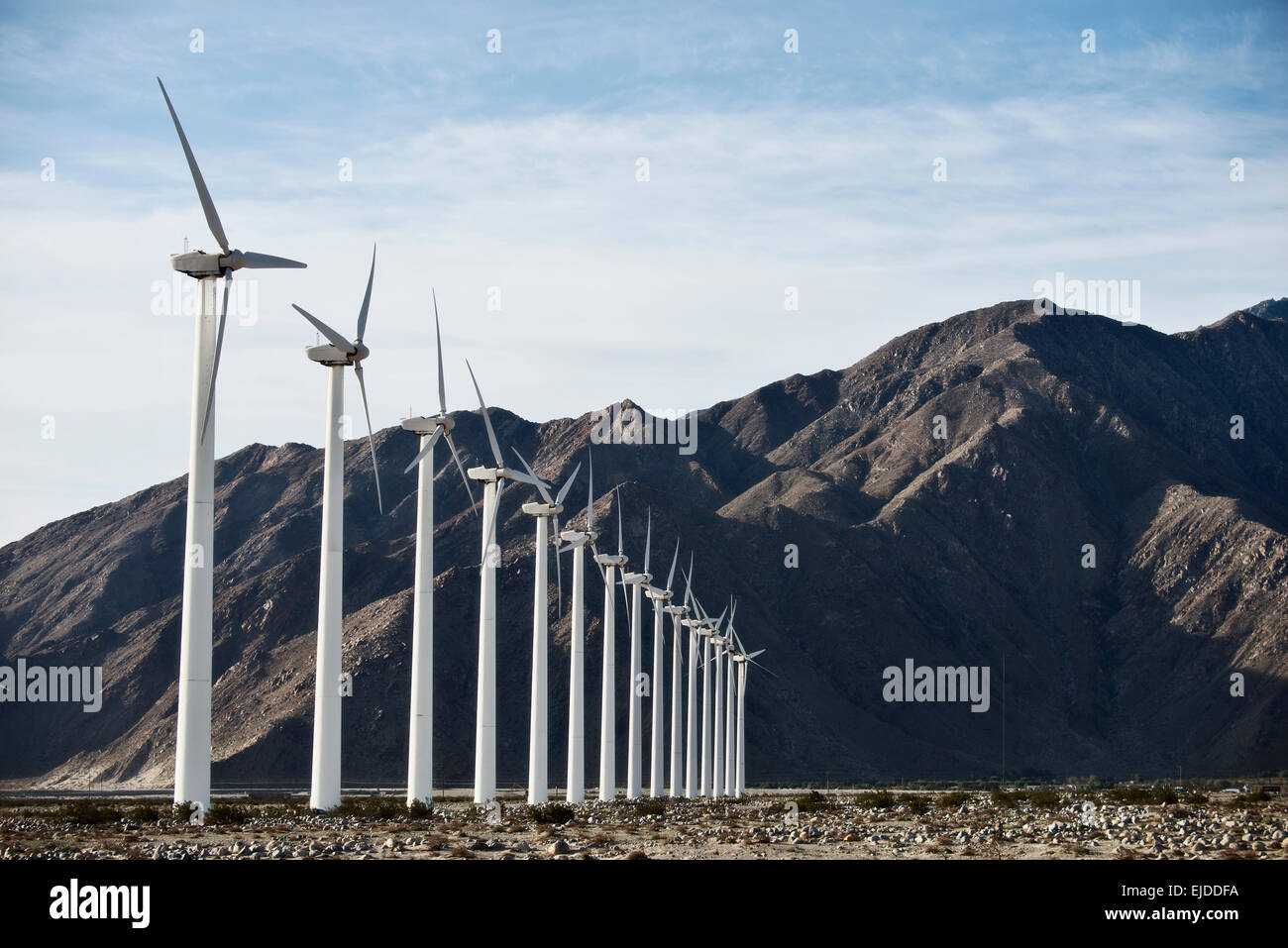 Wind Turbine di potenza nel paesaggio. Un gran numero di poteri di turbina su una pianura contro uno sfondo montano. Foto Stock