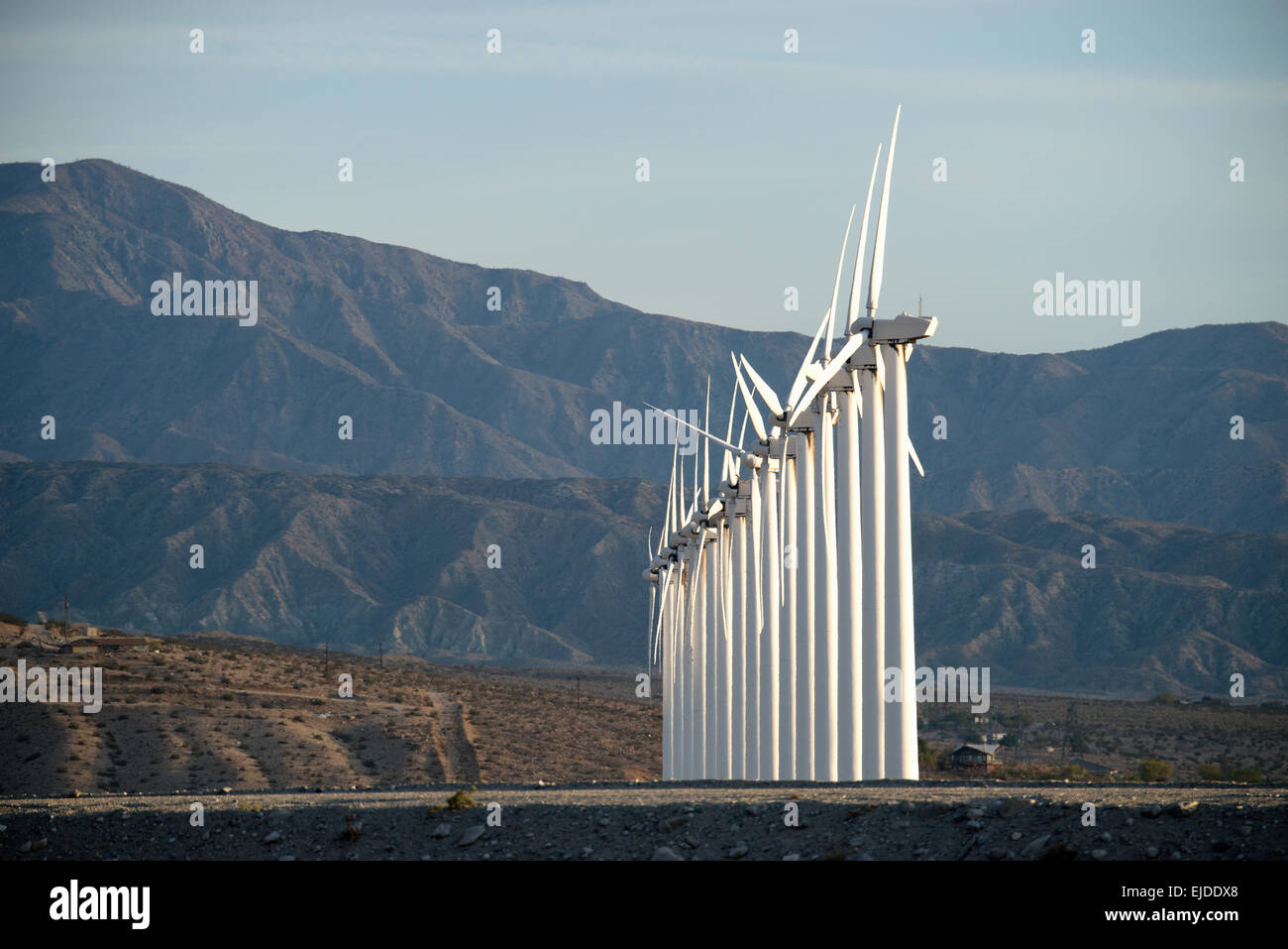 Wind Turbine di potenza nel paesaggio. Un gran numero di poteri di turbina su una pianura contro uno sfondo montano. Foto Stock