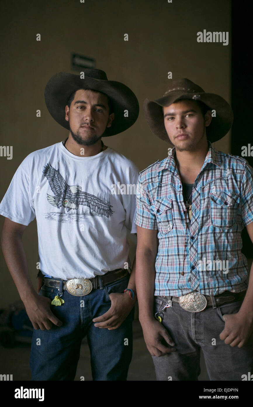 Due giovani uomo dare pongono nel cappello da cowboy. Foto Stock